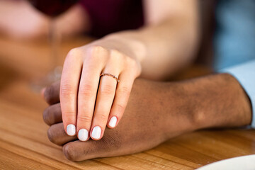 She Said Yes. Closeup Shot Of Female Hand With Engagement Ring Holding Black Boyfriend's Hand...