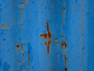 weathered and rusted blue metal surface, likely the exterior of an old shipping container. 