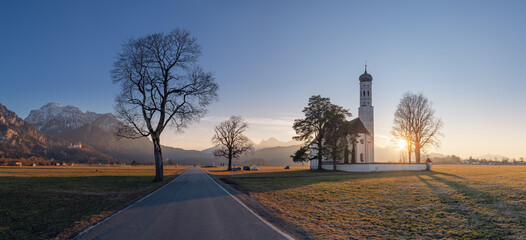 St Coloman building against the backdrop of the Alpine mountains