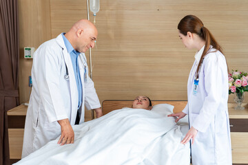 Caucasian senior doctor have morning round ward to check up and diagnosis on patient suffering from...