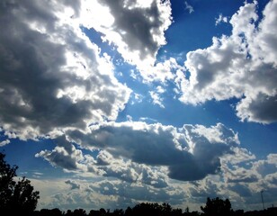 Magnificent blue sky filled with dynamic cumulus clouds bathed in sunlight beauty