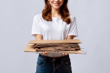 Smiling Woman Collecting Cardboard Waste For Recycling, Holding Stack Of Paper Garbage,...