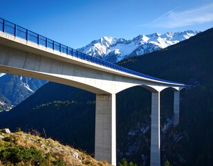 Majestic bridge spanning a valley with snow-capped mountains in the backdrop a stunning