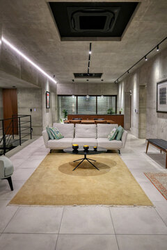 Modern concrete architect-designed house in Motobu district, Okinawa, Japan, with minimalist structure and interiors, with a newly planted tropical garden