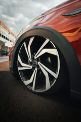 Multi spoke alloy automotive wheel with diamond cut finish, mounted on a low profile tire, highlighting the lowered suspension and fitting flush with the fender.