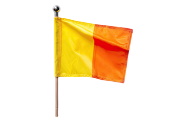 A yellow and orange referee flag, billowing slightly, on a light-brown wooden pole, set against a black background