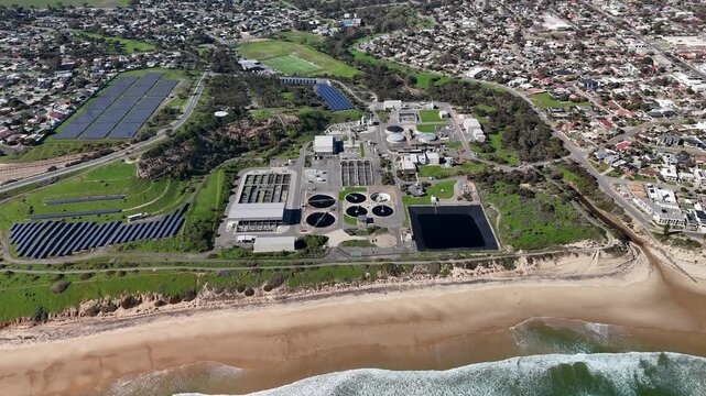 SA Water Christies Beach Wastewater Treatment Plant, O'Sullivan Beach, South Australia: 4K Aerial Drone Footage of Coastal Facility, Clarifier Tanks, Infrastructure, Solar Panels, and Nearby Beach