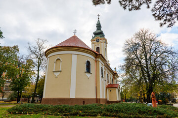 The Monastery of the Holy Trinity in Kikinda features a tall bell tower and soft baroque...