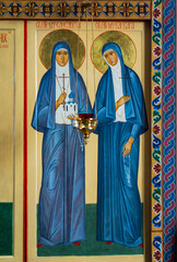 Religious icon depicting two saints in traditional robes with serene expressions in a church setting