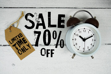 Sale 70% Limited Time Offer text with alarm clock on wooden background