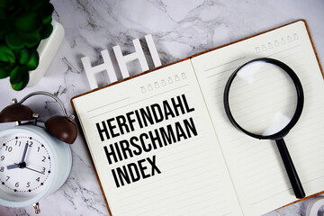 HHI - Herfindahl Hirschman Index acronym on notepad, Marketing concept background