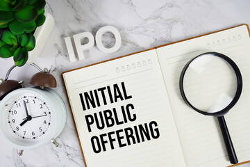 IPO - Initial Public Offering acronym on notepad, Business concept background