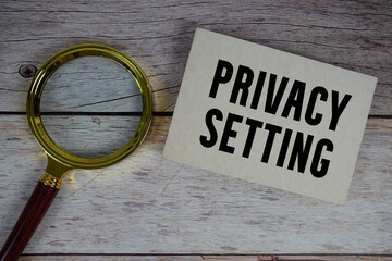 Privacy Setting text written on paper with magnifying glass