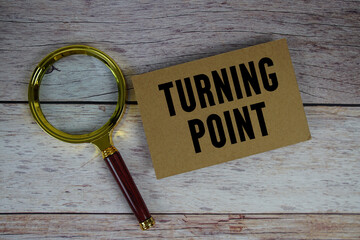 Turning Point text written on paper with magnifying glass