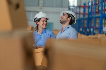 Warehouse worker working in warehouse storage. Foreman or worker work at factory site check up...