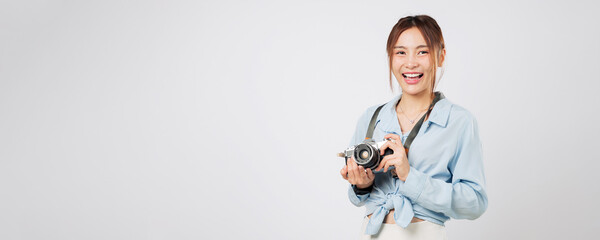 Tourist Asian young woman smiling with photo camera, a stylish tourist on holiday. Summer vacation moment captured in joy and excitement by happy traveler. isolated studio white background