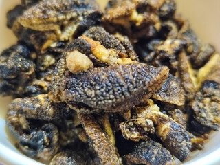 Flourless snail chips have a savory, delicious and crunchy taste. Presented with a white bowl with a natural blur background.