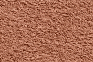 Texture of a rugged and eroded surface in a warm, earthy tone, evoking a sense of age and natural wear