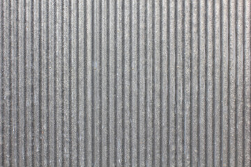Worn Zinc Sheet Wall. Vertical ridged pattern of an old zinc sheet with worn surface, suitable for industrial or urban themes.