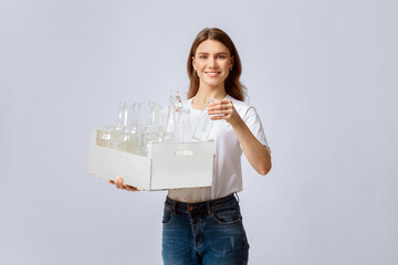 Reuse Of Waste Materials. Portraif Of Smiling Millennial Woman Holding Wooden Box With Empty Glass Bottles For Recycling, Young Enviromental Activist Lady Enjoying Sorting Garbage, Copy Space
