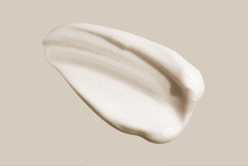 Cosmetic white cream balm texture smudge isolated on beige gray neutral background