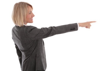 Businesswoman in gray suit pointing to the side, profile view, isolated on white

