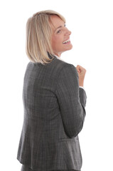 Happy businesswoman turning and smiling in gray suit, isolated on white background

