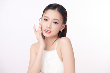 A beautiful young Asian woman with clean, fresh skin against a white background. Skincare, facial...
