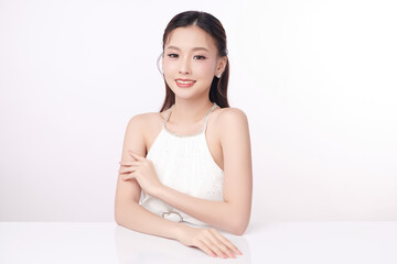 A beautiful young Asian woman with clean, fresh skin against a white background. Skincare, facial...