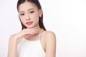 A beautiful young Asian woman with clean, fresh skin against a white background. Skincare, facial...