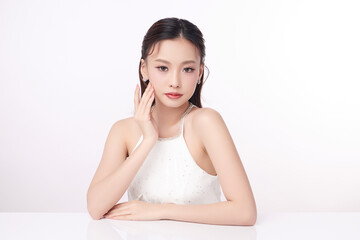 A beautiful young Asian woman with clean, fresh skin against a white background. Skincare, facial...