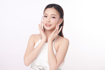 A beautiful young Asian woman with clean, fresh skin against a white background. Skincare, facial...