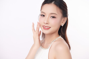 A beautiful young Asian woman with clean, fresh skin against a white background. Skincare, facial...