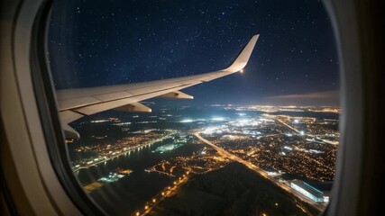 Airplane wing with city lights visible from window at night - Powered by Adobe