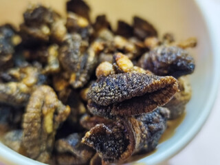 Flourless snail chips have a savory, delicious and crunchy taste. Presented with a white bowl with a natural blur background.