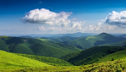 Fototapeta premium vast green landscape of bieszczady mountains under a blue sky dotted with fluffy clouds the scene captures the beauty of nature perfect for outdoor enthusiasts