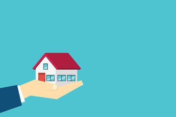 Hand holding house