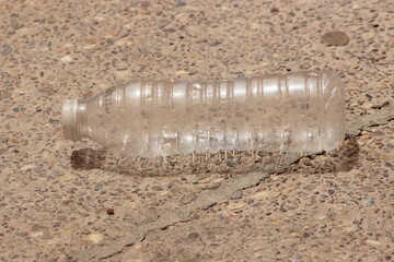 An empty plastic bottle lying on the ground