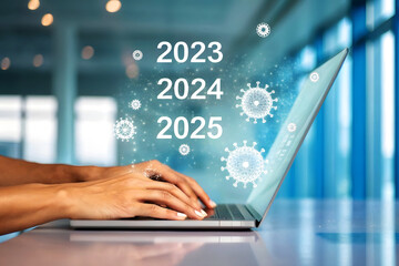 Person typing on laptop with virus graphics and years 2023 2024 2025