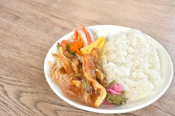 Japanese food bento set grilled salmon fish topping sweet egg and crab stick couple pickled pink ginger and seaweed salad eat couple plain rice on plate