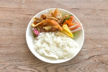 Japanese food bento set grilled salmon fish topping sweet egg and crab stick couple pickled pink ginger and seaweed salad eat couple plain rice on plate