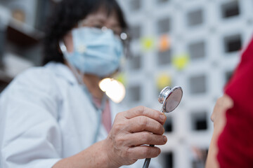 A pediatrician uses a stethoscope during a health examination at the clinic.