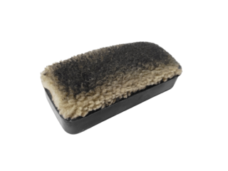 A dark grey whiteboard eraser with dirty fibers