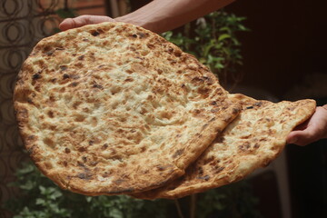 Hands holding tafarnout bread