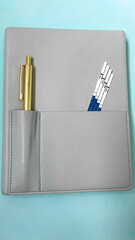 Stylish Gray Notebook with Pens in Pocket for Office or School Use