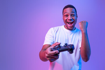 Video Gaming Concept. Euphoric African American Guy With Joystick Celebrating Game Win, Cheerful...