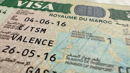 Morocco entry visa sticker in a passport, Morocco visa stamp in a travel passport, Spain Schengen...