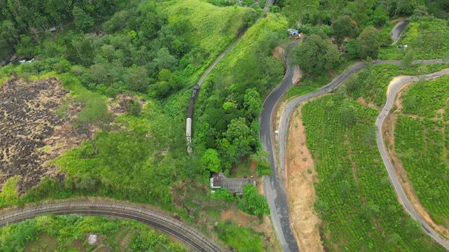 Aerial drone footage of Sri Lankan Sri Lanka train traveling from Kandy to Ella through scenic hills and lush countryside landscapes
