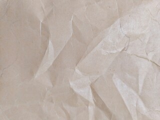 Crumpled brown kraft paper texture with blank copy space for design. Crumpled brown vintage paper surface texture for background.