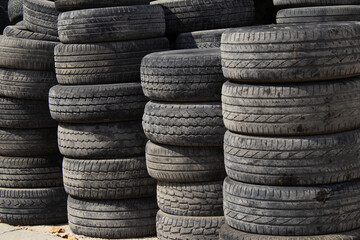 A Large Stack of Used Car Tires
